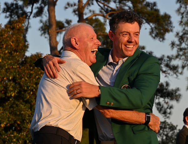 It took Rory McIlroy 17 years to win his first Green Jacket last year. It didn't take long to win No. 2, celebrating with his dad, Gerry McIlroy, Sunday in Augusta. (Hyosub Shin/AJC)