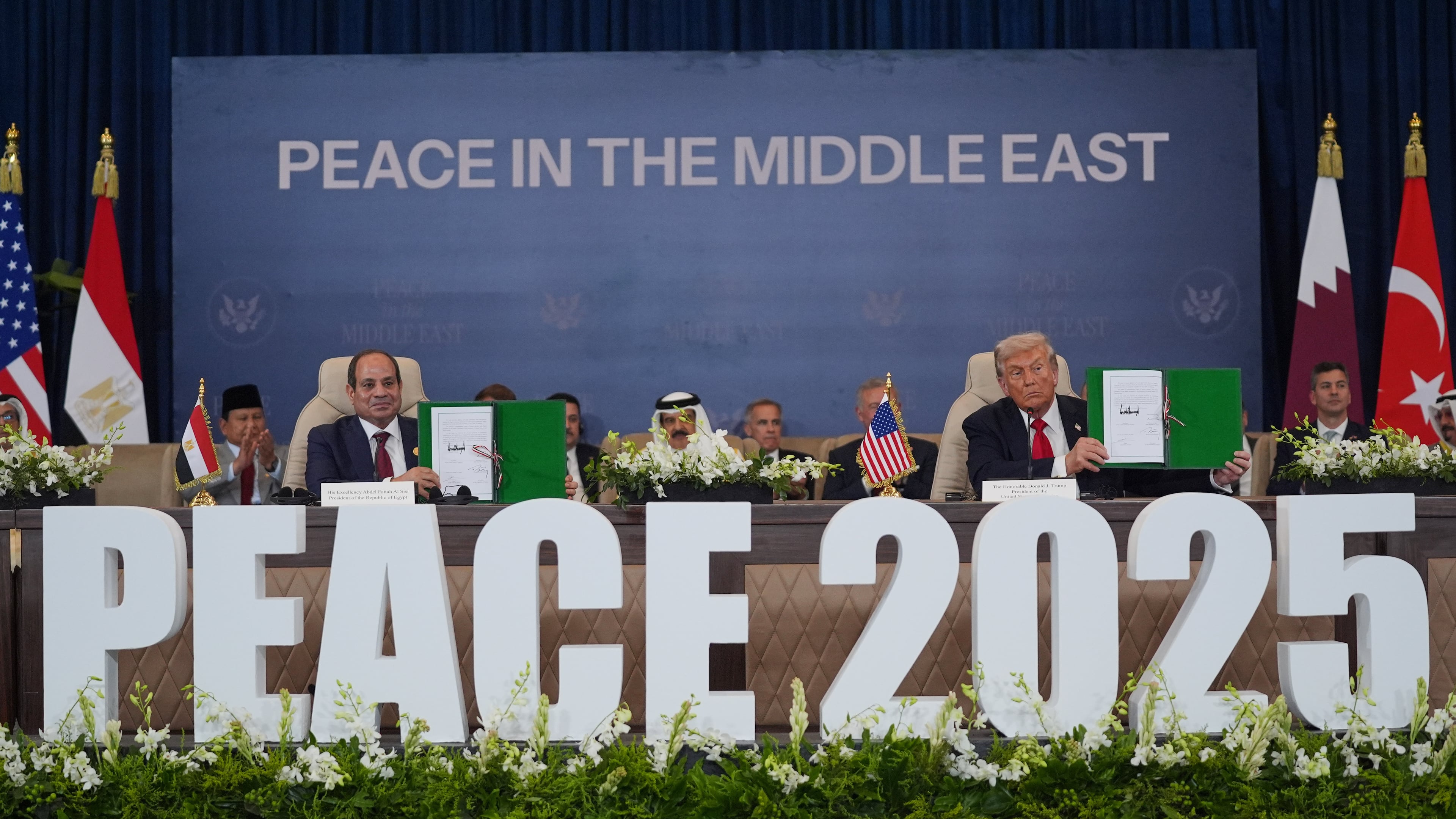 President Donald Trump and Egypt's President Abdel-Fattah el-Sissi hold signed documents during a summit to support ending the more than two-year Israel-Hamas war in Gaza after a breakthrough ceasefire deal, Monday, Oct. 13, 2025, in Sharm El Sheikh, Egypt. (AP Photo/Evan Vucci)