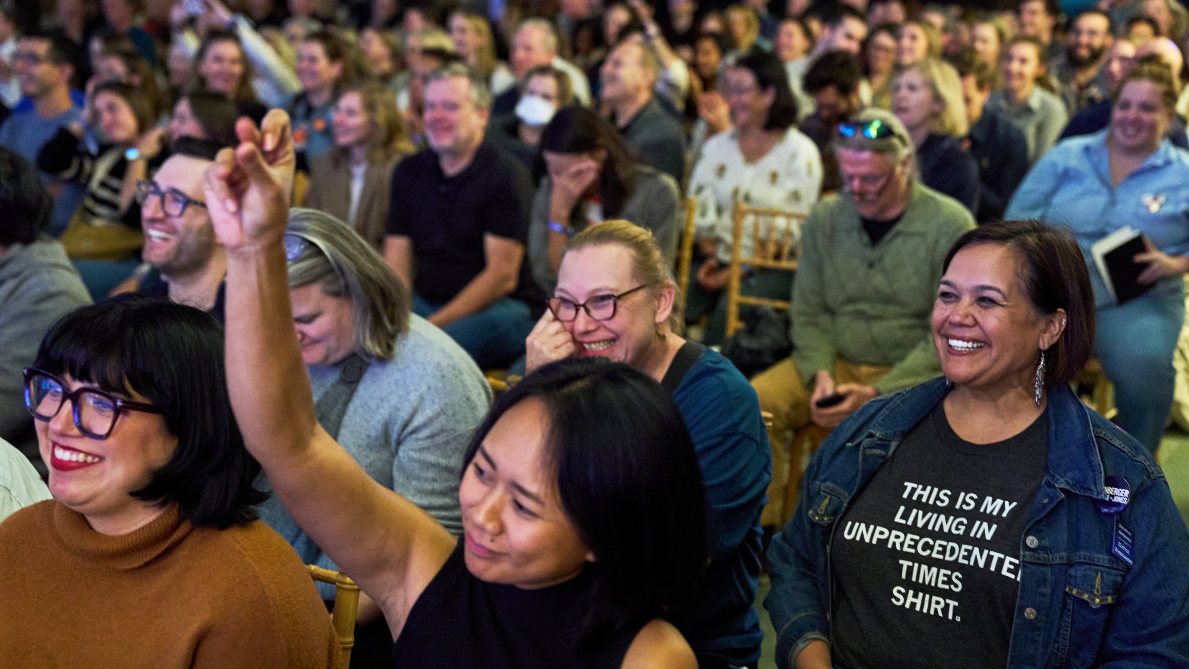 Micaela Mejia Pond, right, and other attendees of Crooked Con, cheer while listening to Sen. Ruben Gallego, D- Ariz., speak, Friday, Nov. 7, 2025, in Washington. (AP Photo/Jacquelyn Martin)