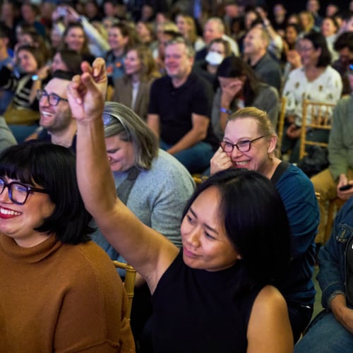 Micaela Mejia Pond, right, and other attendees of Crooked Con, cheer while listening to Sen. Ruben Gallego, D- Ariz., speak, Friday, Nov. 7, 2025, in Washington. (AP Photo/Jacquelyn Martin)