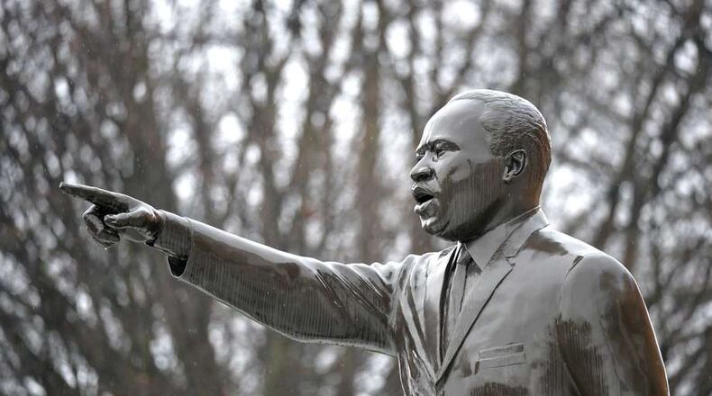A statue of Martin Luther King Jr. can be seen in front of King’s Chapel on Morehouse College campus. HYOSUB SHIN / HSHIN@AJC.COM