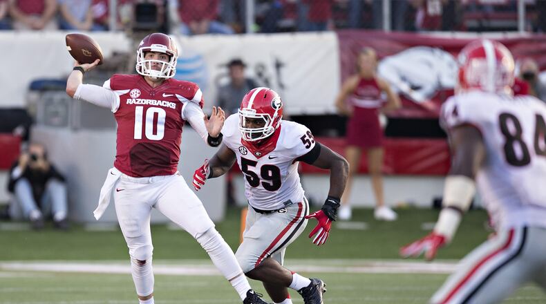 Brandon Allen #10 of the Arkansas Razorbacks throws a pass under pressure from Jordan Jenkins #59 of the Georgia Bulldogs at War Memorial Stadium on October 18, 2014 in Little Rock, Arkansas. The Bulldogs defeated the Razorbacks 45-32. (Photo by Wesley Hitt/Getty Images)