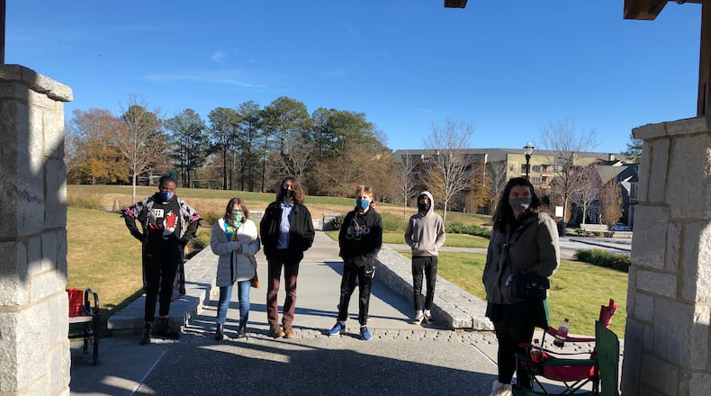 Junior high students at the Academy, a hybrid home-school option for students that combines in-person and self-directed learning, are pictured with Karen Seaver, a student teacher from Agnes Scott. Image courtesy of the Academy.