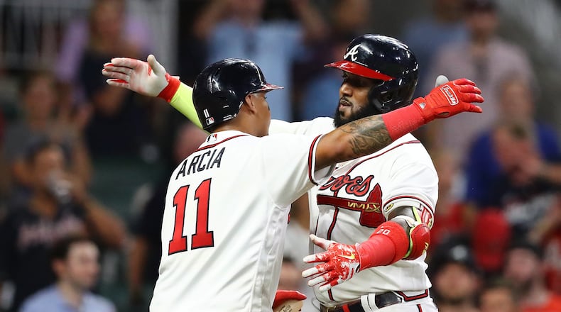 Braves designated hitter Marcell Ozuna gets a hug from Orlando Arcia after hitting a solo homer to take a 10-1 lead over the Philadelphia Phillies during the seventh inning of a MLB baseball game on Tuesday, August 2, 2022, in Atlanta.   “Curtis Compton / Curtis Compton@ajc.com