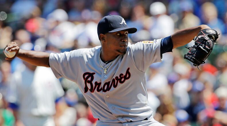 Atlanta Braves starter Julio Teheran throws against the Chicago Cubs during the first inning of a baseball game in Chicago, Sunday, July 13, 2014. (AP Photo/Nam Y. Huh)