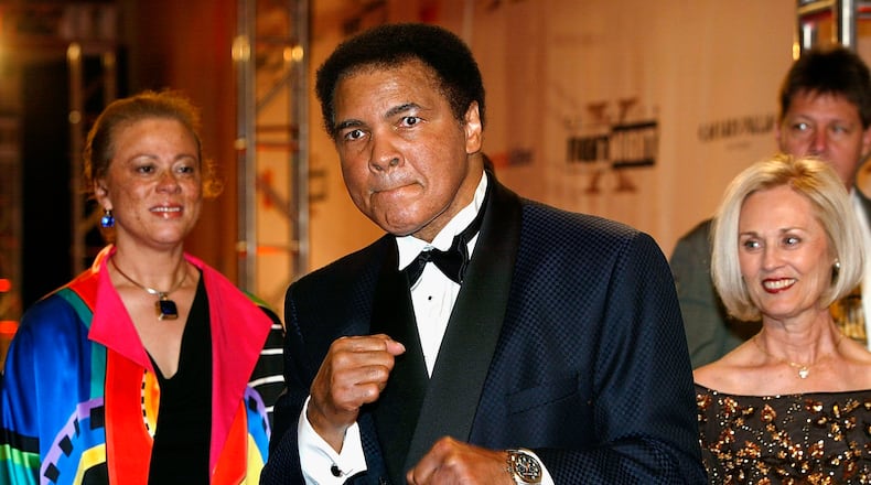 PHOENIX, AZ - MARCH 27: Former heavyweight champion of the world Muhammad Ali (C) and wife Lonnie Ali (L) arrives at 'Celebrity Fight Night X', a charity event to raise money for the Muhammad Ali Parkinson Research Center at Barrow Neurological Institute March 27, 2004, in Pheonix, Arizona. The 'Muhammad Ali Awards' are a way to acknowledge leaders in sports, entertainment and business communities who best represent the qualities associated with Ali's fight to find a cure. (Photo by Carlo Allegri/Getty Images)
