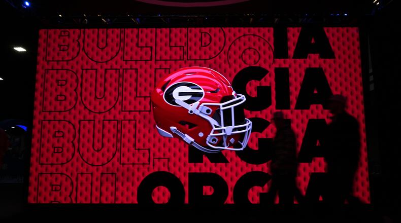 Football fans arrive for The Dr Pepper SEC FanFare ahead of the SEC Championship football game between Georgia and Texas at the Mercedes-Benz Stadium, Saturday, December 7, 2024, in Atlanta. (Hyosub Shin / AJC)