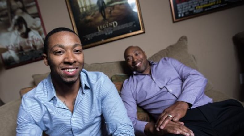 Kneico Daniels, left, sits with his father, Rolan Daniels, at their home in Doraville recently. Kneico will graduate Wednesday from DeKalb County’s Elizabeth Andrews High School.