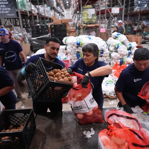 Volunteers at the San Antonio Food Bank load bags of potatoes for a food distribution for SNAP recipients and other households affected by the federal shutdown, Thursday, Nov. 6, 2025, in San Antonio. (AP Photo/Eric Gay)