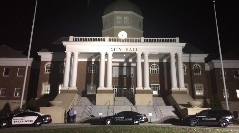 Roswell Police vehicles were parked in front of city hall before the Monday evening meeting.