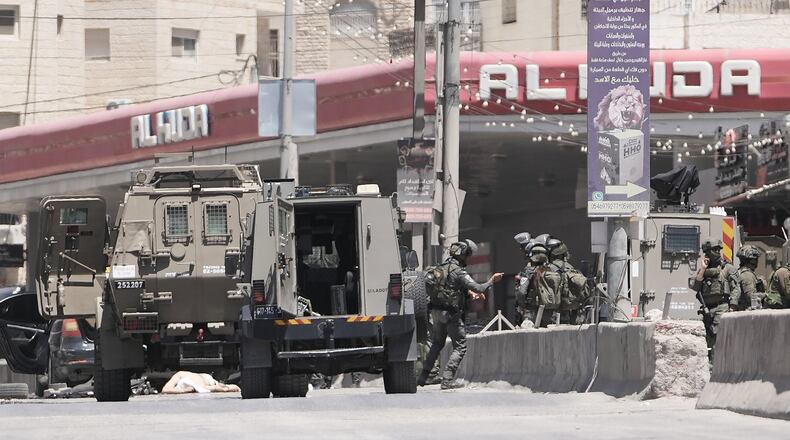 Israeli border police officers operate in the West Bank refugee camp of Qalandia, after Israeli forces shot and killed a suspected militant who opened fire on troops Monday, May 11, 2026. (AP Photo/Mahmoud Illean)