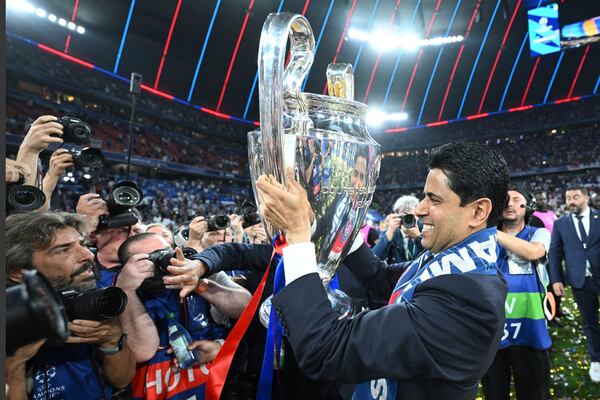 PSG's President Nasser Al-Khelaifi celebrates with the trophy after winning the Champions League final soccer match between Paris Saint Germain and Inter Milan, at the Allianz Arena in Munich, Germany, Saturday, May 31, 2025. (Robert Michael/dpa via AP)