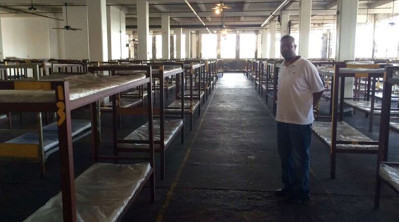Volunteer Troy Harris in the large bedroom at Peachtree-Pine where nearly 400 men sleep. Photo by Bill Torpy