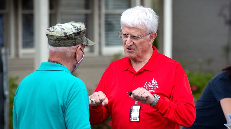 Lilburn Mayor Tim Dunn (right) talks with David Boltze. Lilburn's city council Monday will consider taking tax collection in-house. (Photo: Steve Schaefer for The Atlanta Journal-Constitution) AJC FILE PHOTO