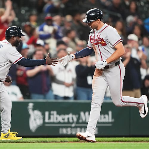 Braves first baseman Matt Olson greets third base coach Tommy Watkins while jogging home after hitting a solo home run against the Mariners on Tuesday, May 5, 2026, in Seattle. (Lindsey Wasson/AP)