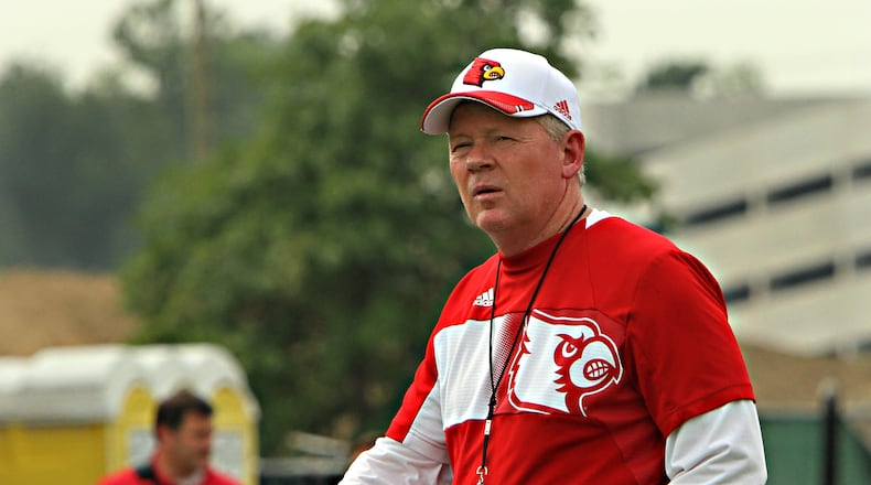 Louisville head coach Bobby Petrino watches his college football team during the first day of practice in Louisville, Ky., Tuesday, Aug. 5, 2014. (AP Photo/Garry Jones) S.I. reports Bobby Petrino and Todd Grantham are already feuding. Surprise!. (AP photo)