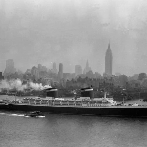 FILE - The SS United States travels along the Hudson River as it begins its first voyage to Europe from New York, July 3, 1952, with the view of the Midtown Manhattan skyline including the Empire State Building at center right. (AP Photo/Jack Harris, File)