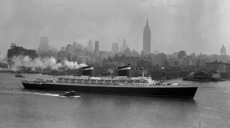 FILE - The SS United States travels along the Hudson River as it begins its first voyage to Europe from New York, July 3, 1952, with the view of the Midtown Manhattan skyline including the Empire State Building at center right. (AP Photo/Jack Harris, File)