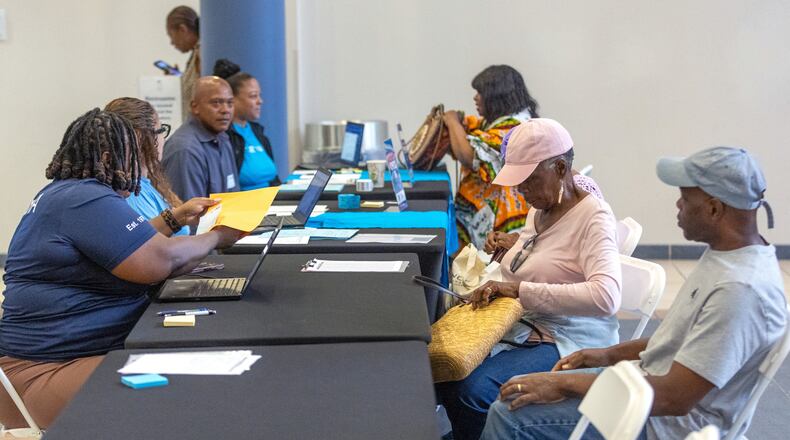 Volunteers help participants during the application assistance session at Atlanta Metro State College on Tuesday, Aug 6, 2024, apply for the anti-displacement tax relief fund program. (Steve Schaefer/AJC)