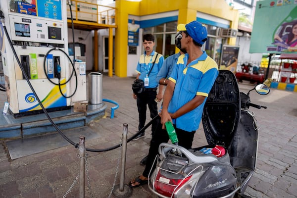 An Indian man fills petrol in a two wheeler at a fuel pump in Prayagraj, in the northern Indian state of Uttar Pradesh, Monday, May 5, 2025. (AP Photo/Rajesh Kumar Singh)