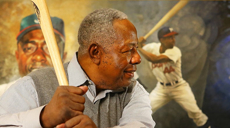 Braves legend Hank Aaron shows he still has his form from his four decades as a slugger.