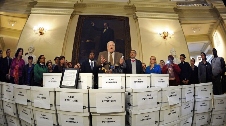 Deacon Richard Tolcher of the Catholic Archdiocese of Atlanta, center, helps deliver 26,000 letters to Gov. Nathan Deal signed by hundreds of Georgia faith leaders asking that Kelly Gissendaner be spared from execution. David Tulis/AJC Special
