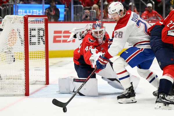 Montreal Canadiens center Christian Dvorak (28) skates with the puck against Washington Capitals goaltender Logan Thompson (48) in the second period of Game 5 of a first-round NHL hockey playoff series Wednesday, April 30, 2025, in Washington. (AP Photo/Nick Wass)