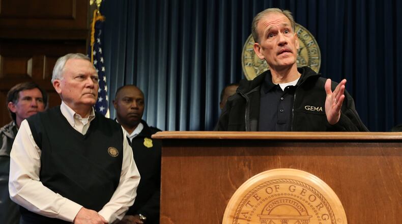 Georgia Gov. Nathan Deal watches GEMA Director Charlie English answer a question during a contentious press conference Wednesday January 29, 2014 in the Governor’s office at the State Capitol. BEN GRAY / BGRAY@AJC.COM