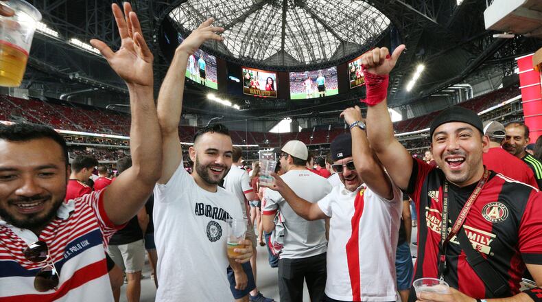Atlanta United fans Miguel Gallardo (from left), Ricardo Goncalves, Claudio Magana, and Miguel Ortiz cheer after Croatia scores a goal while watching the World Cup final on the halo board in Mercedes-Benz Stadium before their team takes on the Seattle Sounders in a MLS soccer game on Sunday, July 15, 2018, in Atlanta. Croatia, the crowd favorite, fell 4-2 to France. Curtis Compton/ccompton@ajc.com