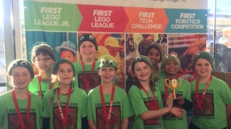 The Cardinal Crushers display the trophy they won for best presentation at the 2017 FIRST LEGO League State Championship at Georgia Tech.