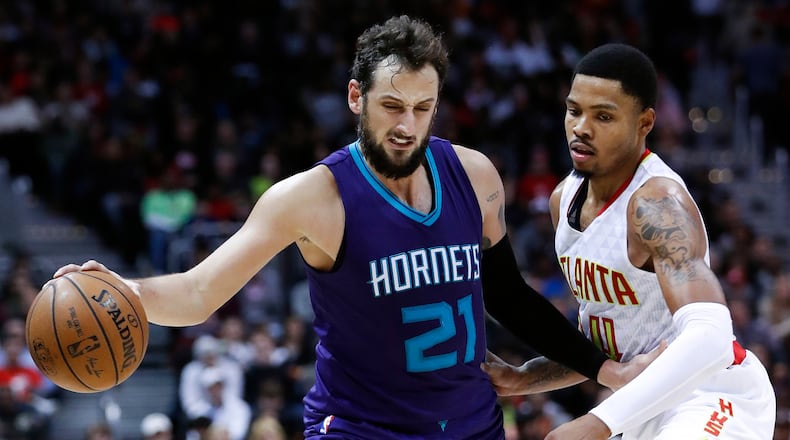 Charlotte Hornets guard Marco Belinelli (21) works against Atlanta Hawks forward Kent Bazemore (24) in the second half of an NBA basketball game Saturday, Dec. 17, 2016, in Atlanta. (AP Photo/John Bazemore)