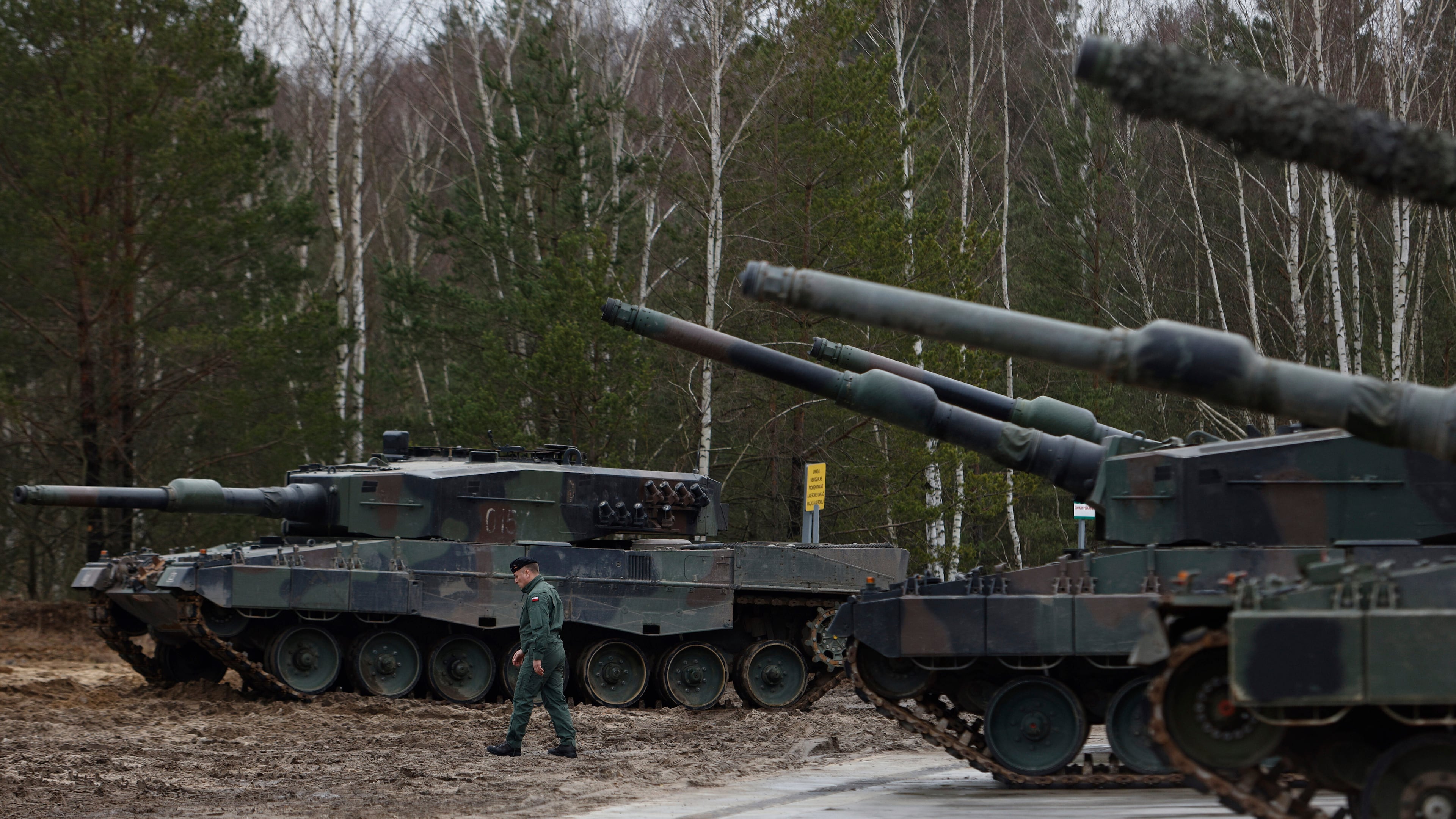 FILE - A Polish soldier walks next to the Leopard 2 tanks during a training at a military base and test range in Swietoszow, Poland, Monday, Feb. 13, 2023. (AP Photo/Michal Dyjuk, File)