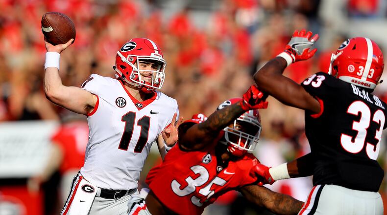 Jake Fromm gets off a pass while tailback Brian Herrien blocks in the annual G-Day spring intrasquad football game. More than 82,000 fans attended the game Saturday at Sanford Stadium in Athens. (Curtis Compton/ccompton@ajc.com)