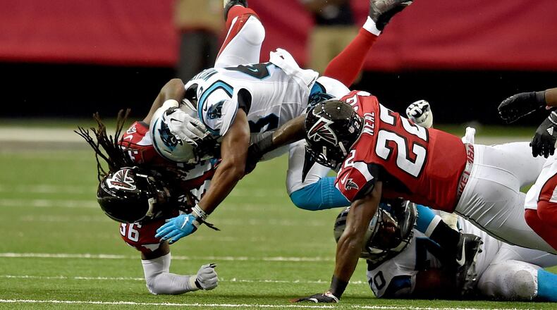 Carolina Panthers running back Fozzy Whittaker is brought down by Atlanta Falcons Kemal Ishmael and Keanu Neal during the second quarter in the Georgia Dome Sunday October 2, 2016. BRANT SANDERLIN/BSANDERLIN@AJC.COM