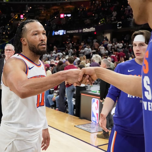 New York Knicks guard Jalen Brunson (11) celebrates with teammates after winning Game 3 in the Eastern Conference finals NBA basketball playoffs series against the Cleveland Cavaliers in Cleveland, Saturday, May 23, 2026. (AP Photo/Sue Ogrocki)