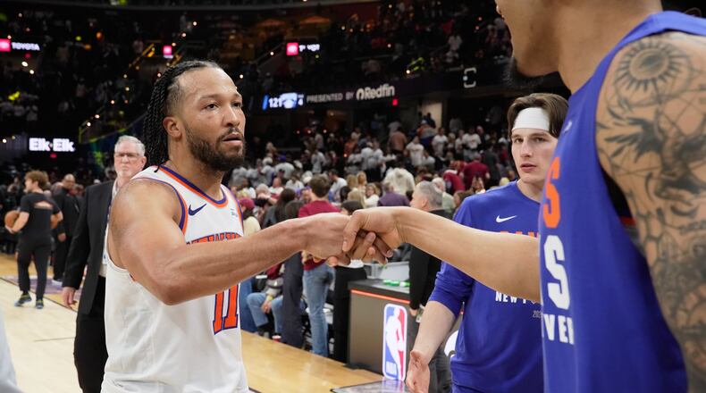 New York Knicks guard Jalen Brunson (11) celebrates with teammates after winning Game 3 in the Eastern Conference finals NBA basketball playoffs series against the Cleveland Cavaliers in Cleveland, Saturday, May 23, 2026. (AP Photo/Sue Ogrocki)