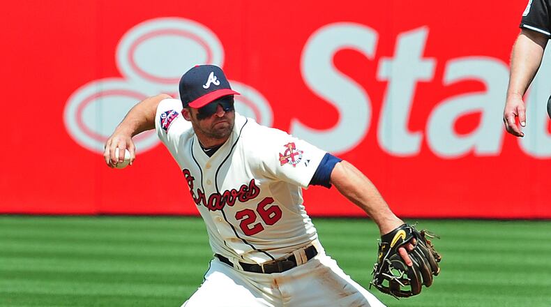 ATLANTA, GA - APRIL 27: Dan Uggla #26 of the Atlanta Braves throws out a runner from his knees during the 6th inning against the Cincinnati Reds at Turner Field on April 27, 2014 in Atlanta, Georgia. (Photo by Scott Cunningham/Getty Images) Braves second baseman Dan Uggla has had some struggles at the plate and the field. (Scott Cunningham / Getty Images)