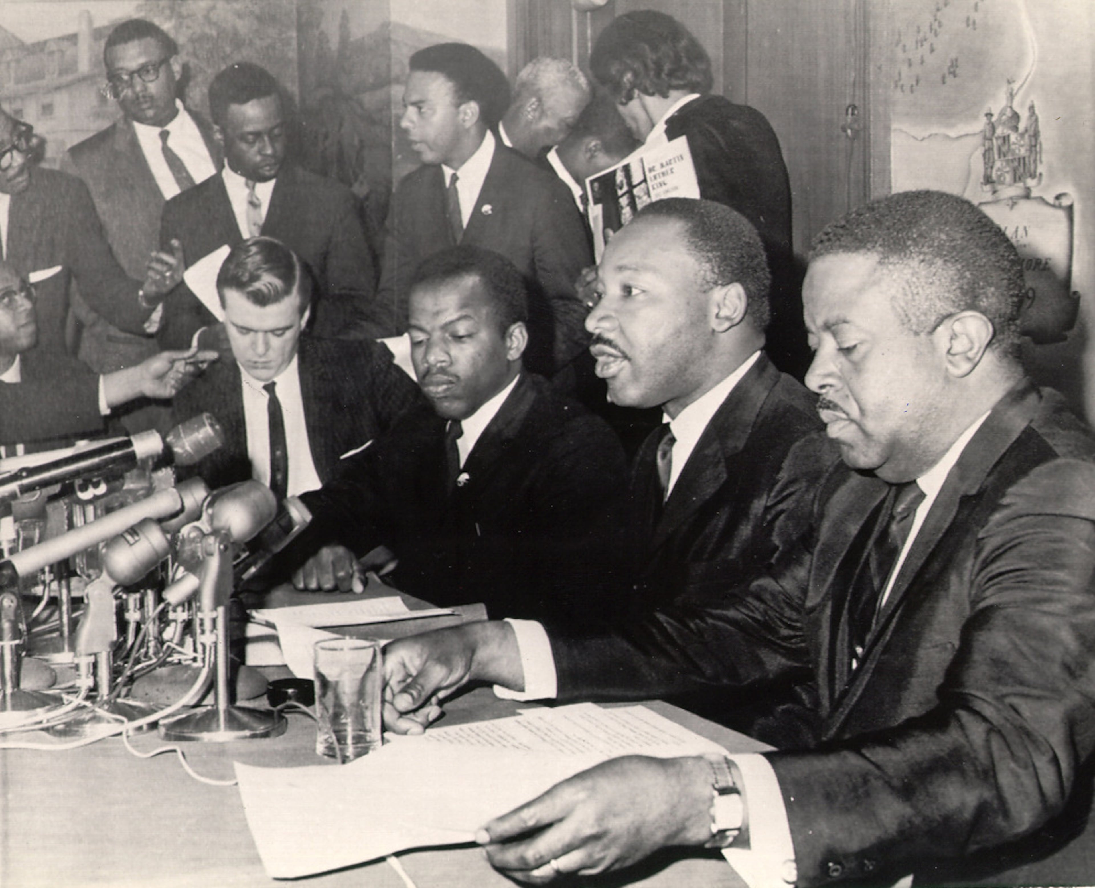 In this photo taken April 2, 1965, Rev. Martin Luther King is flanked by Rev. Ralph Abernathy (right), then a lieutenant in King's Southern Christian Leadership Conference, and John Lewis (third from right), then-chairman of the Student Nonviolent Coordinating Committee. Andrew Young stands behind Lewis. (Courtesy of AP)