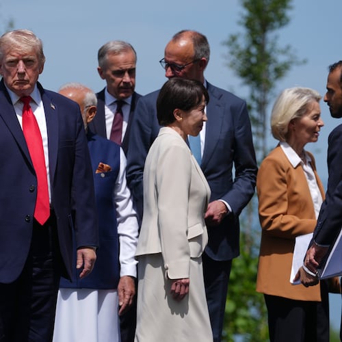 U.S. President Donald Trump, left, gestures prior to a group photo of G7 leaders and invited nations during the G7 summit in Evian-les-Bains, France, Tuesday, June 16, 2026. (AP Photo/Thibault Camus)