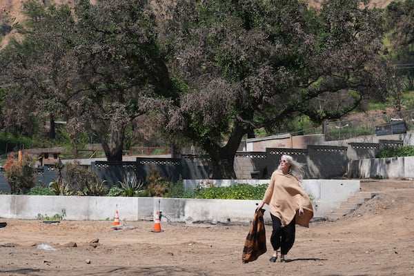 Kathryn Frazier visits her fire-damaged property, which she plans to rebuild, in Altadena, Calif., on Tuesday, April 22, 2025. (AP Photo/Damian Dovarganes)