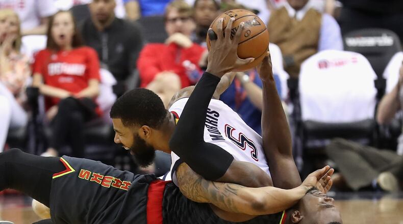Markieff Morris of the Washington Wizards and Paul Millsap of the Atlanta Hawks go after a loose ball in the first half in Game One of the Eastern Conference Quarterfinals during the 2017 NBA Playoffs at Verizon Center on April 16, 2017 in Washington, DC. A jump ball was called on the play. (Photo by Rob Carr/Getty Images)