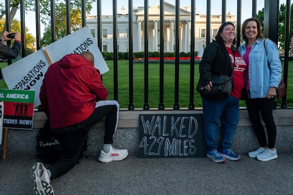 Pastor Robert Turner stops to pray in front of the White House as part for his monthly walk from Baltimore to Washington to raise awareness of reparations on Wednesday, April 16, 2025, in Washington. (AP Photo/Nathan Howard)