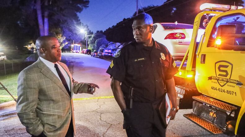 Maj. Adam Lee III, left, and Sgt. J.C. Jackson investigate a double homicide Wed., June 8, 2016, in southeast Atlanta. JOHN SPINK / JSPINK@AJC.COM