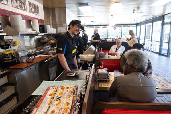 Allen Dasher talks with a customer at the Waffle House on Peachtree Road in Brookhaven on Friday, Aug. 14, 2026. (Ben Gray for the AJC)