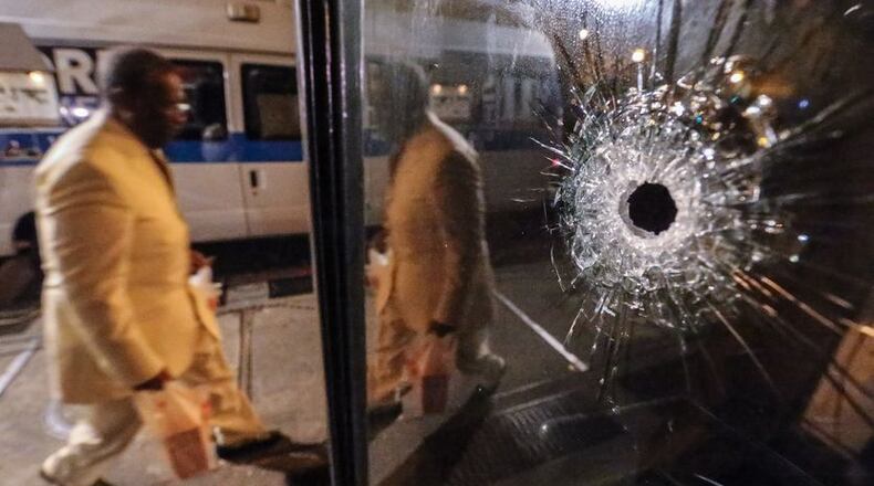 Investigators called out to investigate a shooting in the area of 75 Poplar Street NW found four people shot Wednesday, Feb. 24, 2016. JOHN SPINK/ JSPINK@AJC.COM