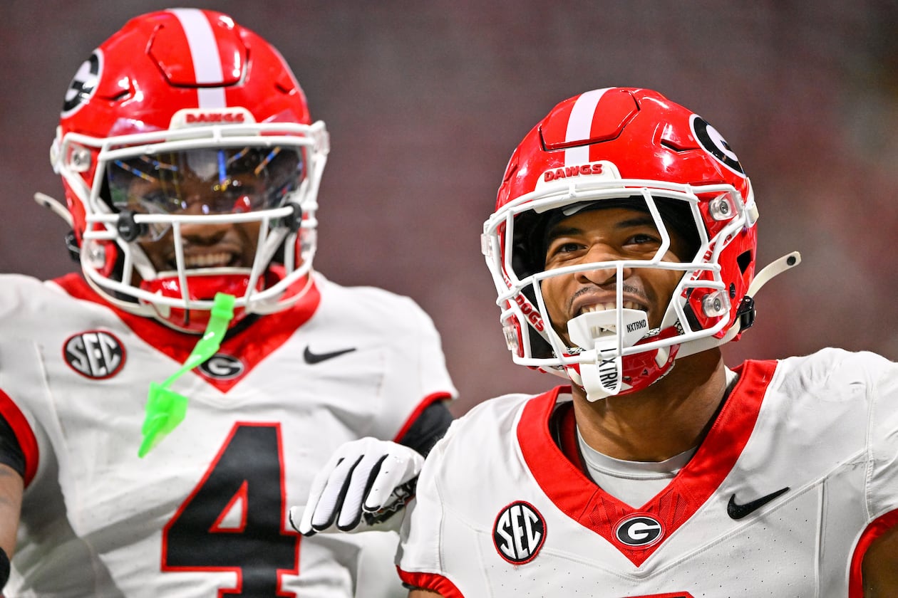 Georgia defensive back Daylen Everette (6)) celebrates with Kj Bolden (4) after intercepting a pass from Alabama quarterback Ty Simpson during the first half of the SEC Championship game at Mercedes-Benz Stadium, Saturday, Dec. 6, 2025, in Atlanta. (Hyosub Shin / AJC)
