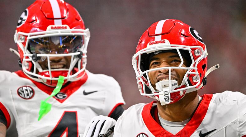 Georgia defensive back Daylen Everette (6)) celebrates with Kj Bolden (4) after intercepting a pass from Alabama quarterback Ty Simpson during the first half of the SEC Championship game at Mercedes-Benz Stadium, Saturday, Dec. 6, 2025, in Atlanta. (Hyosub Shin / AJC)