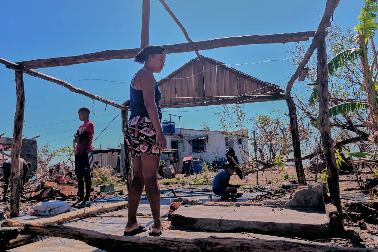 Elizandra Sorrilla poses for a photo in the ruins of her home, which was destroyed by Hurricane Melissa, in El Aserradero, Cuba, Sunday, Nov. 16, 2025. (AP Photo/Milexsy Duran)