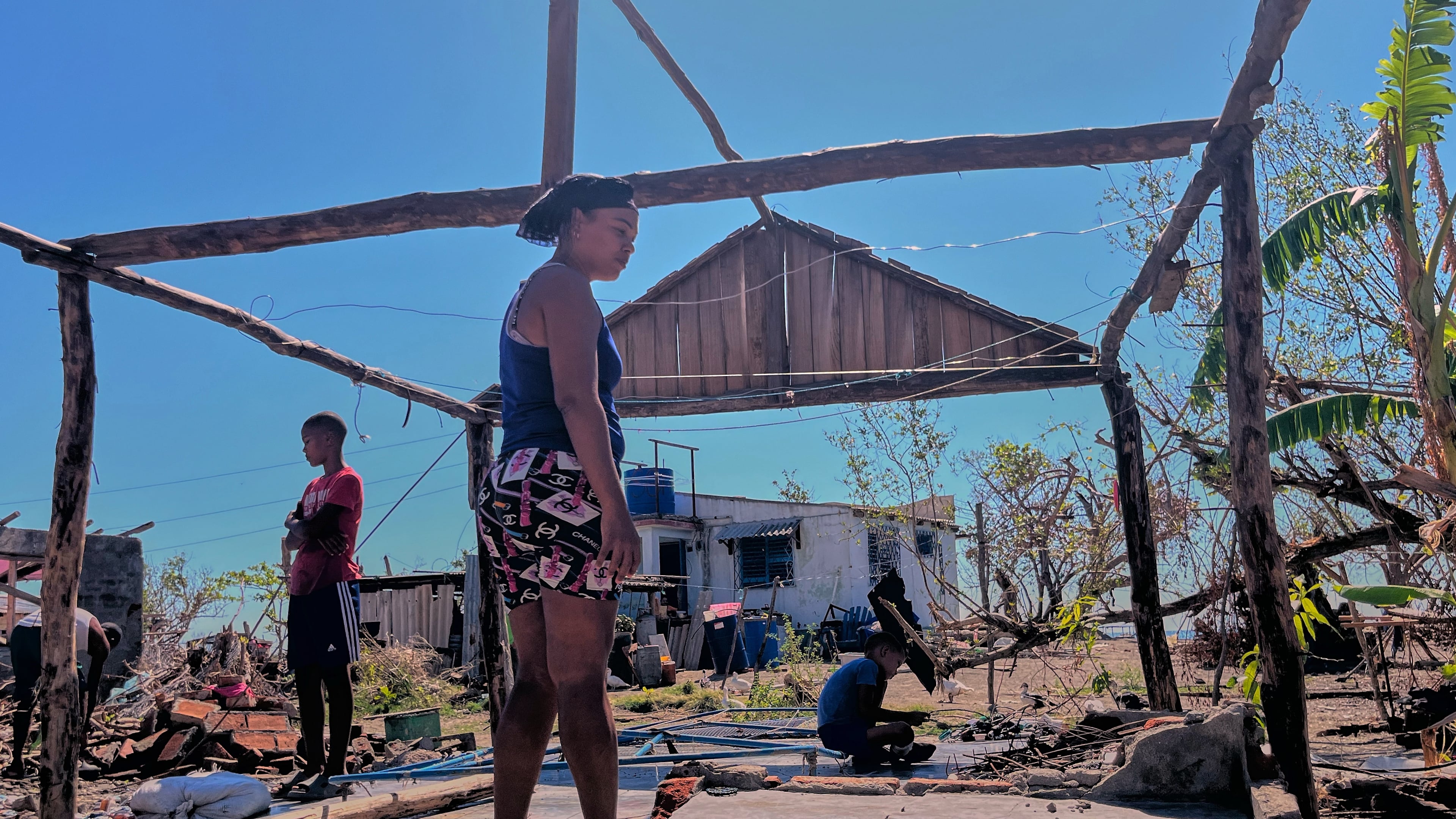 Elizandra Sorrilla poses for a photo in the ruins of her home, which was destroyed by Hurricane Melissa, in El Aserradero, Cuba, Sunday, Nov. 16, 2025. (AP Photo/Milexsy Duran)