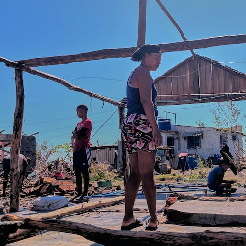 Elizandra Sorrilla poses for a photo in the ruins of her home, which was destroyed by Hurricane Melissa, in El Aserradero, Cuba, Sunday, Nov. 16, 2025. (AP Photo/Milexsy Duran)